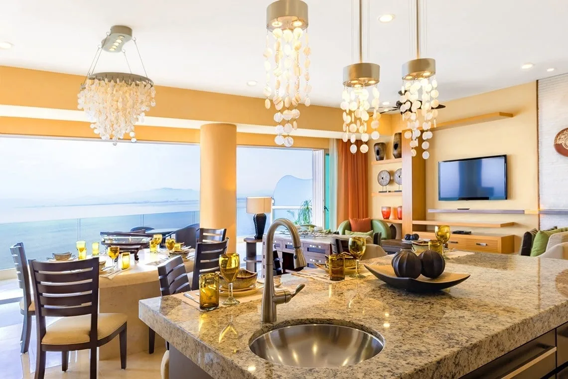Granite kitchen island opening onto the dining room and ocean view